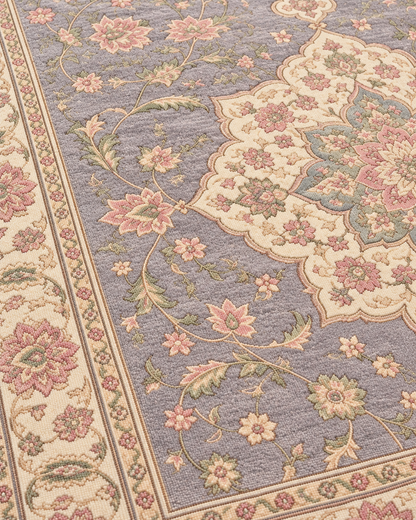 Close-up of H02 Tabriz Medallion showing blush and sage flowers against the lavender-grey field in knotted wool