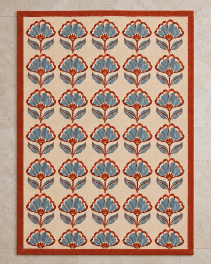 H05 Jaipur Block rug from above, rows of small block-print flowers in rust and powder blue on cream with a rust border
